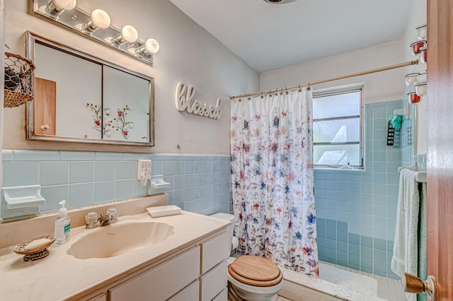 bathroom with walk in shower, tile walls, vanity, and toilet