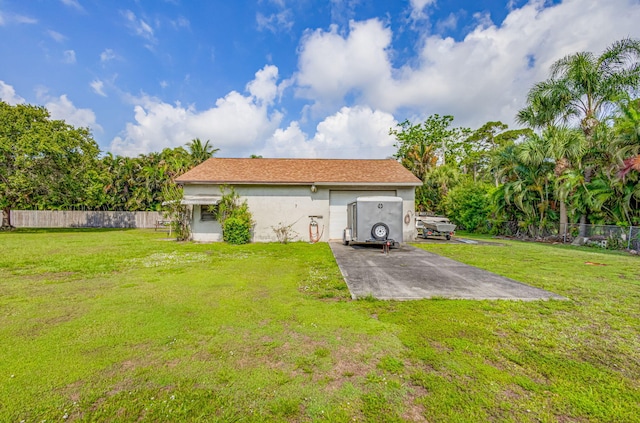 rear view of property featuring a yard