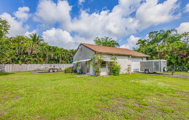 exterior space with a garage and a yard