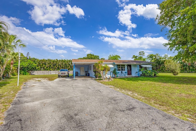 ranch-style house with a front lawn and a carport