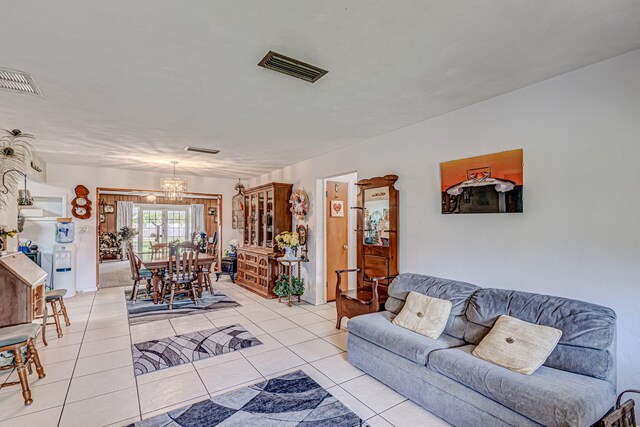 living room featuring an inviting chandelier and light tile floors