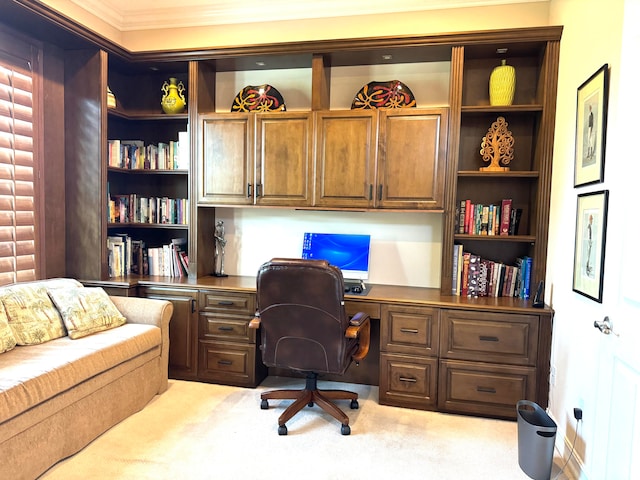 carpeted home office with built in desk and crown molding