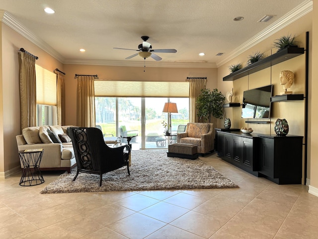 tiled living room featuring ceiling fan, ornamental molding, a textured ceiling, and a wealth of natural light