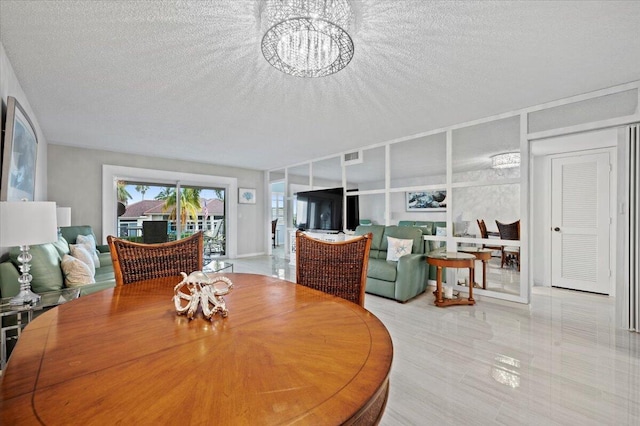 tiled dining room featuring a notable chandelier and a textured ceiling