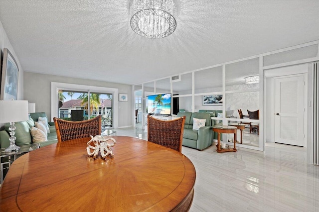 tiled dining space with a textured ceiling and a chandelier