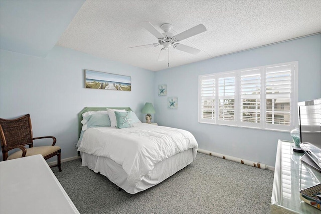 carpeted bedroom featuring ceiling fan and a textured ceiling