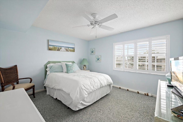 carpeted bedroom with ceiling fan and a textured ceiling