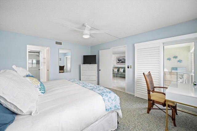 bedroom featuring carpet, ceiling fan, and a textured ceiling