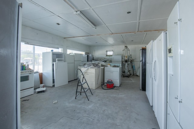 interior space featuring white appliances and separate washer and dryer