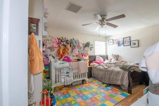 bedroom with wood-type flooring and ceiling fan