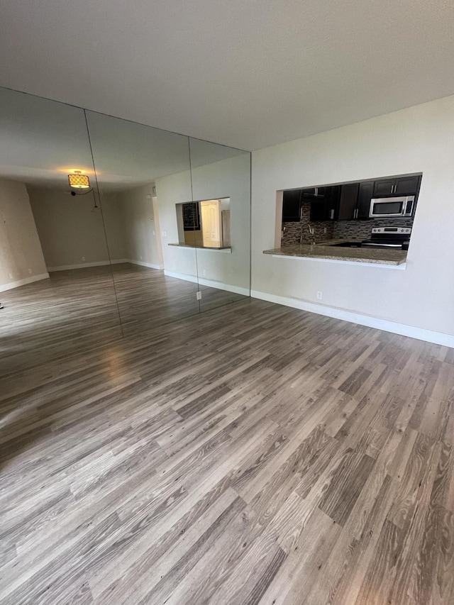 unfurnished living room with wood-type flooring