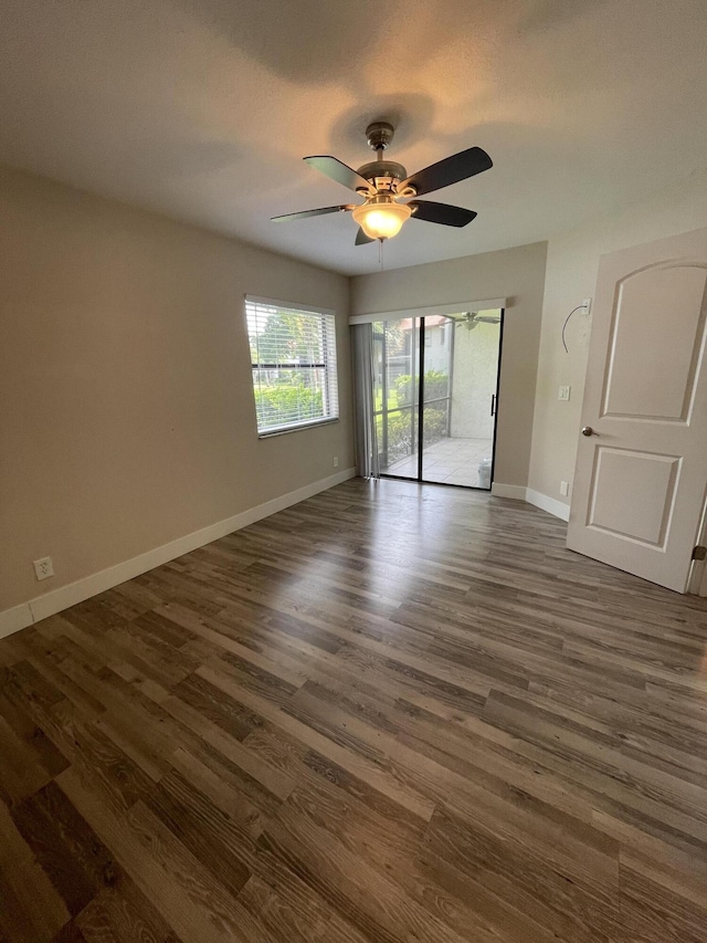 unfurnished room with dark wood-type flooring and ceiling fan