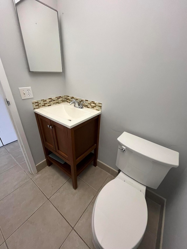 bathroom featuring tile flooring, large vanity, and toilet