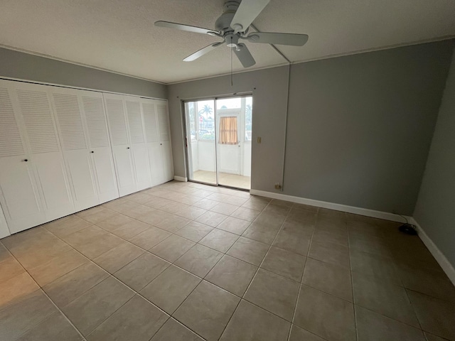 unfurnished bedroom featuring tile flooring and ceiling fan