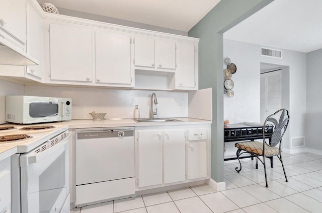 kitchen with white appliances, ventilation hood, light tile flooring, sink, and white cabinetry