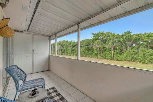 sunroom / solarium featuring lofted ceiling