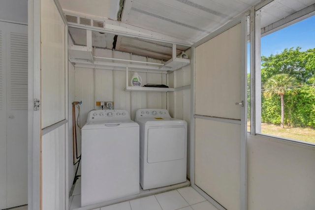 laundry room featuring independent washer and dryer, light tile floors, and washer hookup