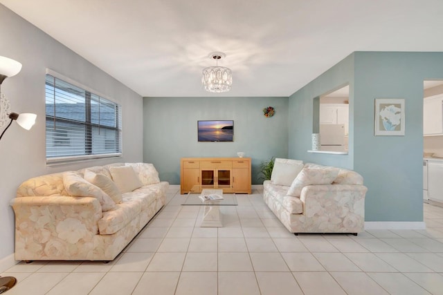 tiled living room featuring a notable chandelier