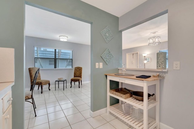 interior space with light tile floors and an inviting chandelier