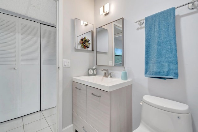 bathroom featuring vanity, toilet, and tile floors