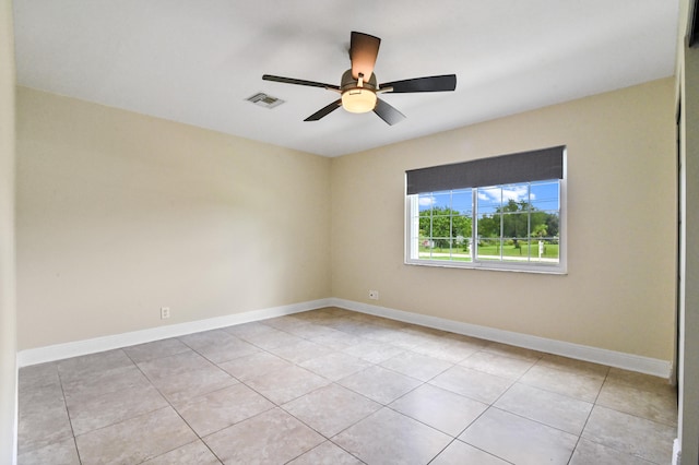 unfurnished room featuring ceiling fan and light tile patterned floors