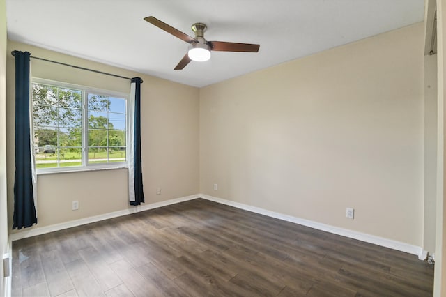 empty room featuring ceiling fan and dark hardwood / wood-style flooring