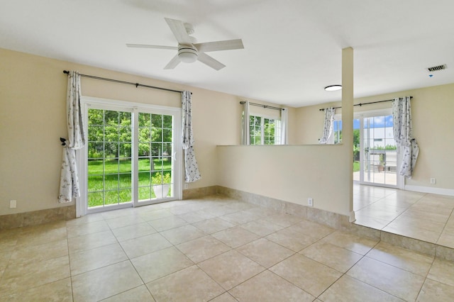 tiled empty room featuring ceiling fan