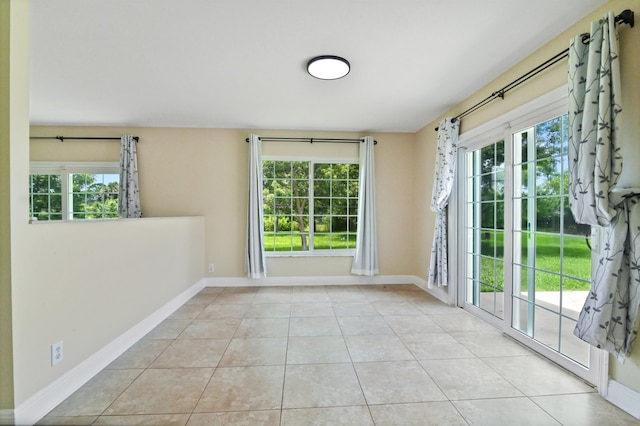 unfurnished room featuring light tile patterned floors