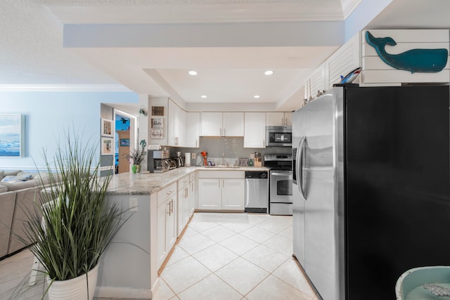 kitchen with crown molding, stainless steel appliances, white cabinets, sink, and light tile flooring