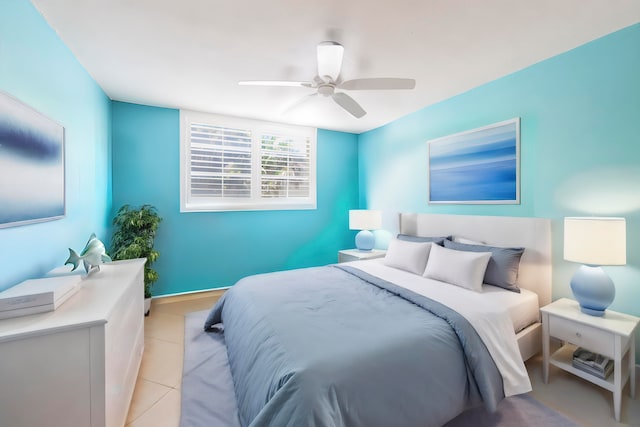 tiled bedroom featuring ceiling fan