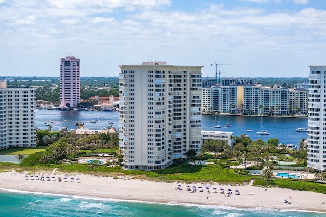 drone / aerial view with a beach view and a water view