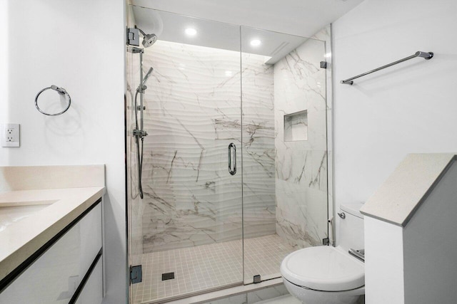 bathroom with an enclosed shower, toilet, and vanity