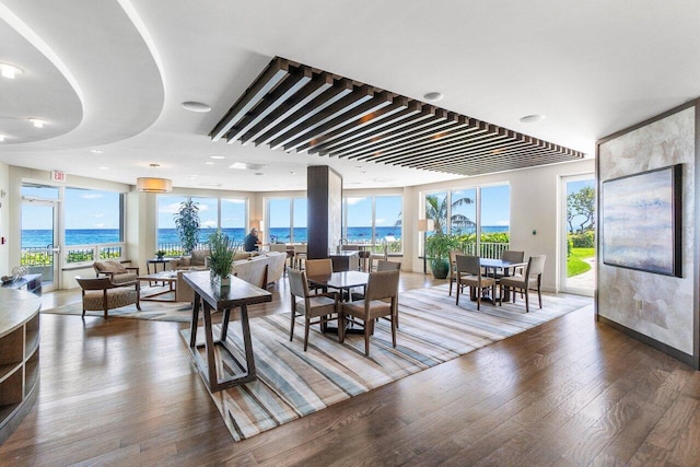 living room featuring a wealth of natural light, a water view, and hardwood / wood-style floors