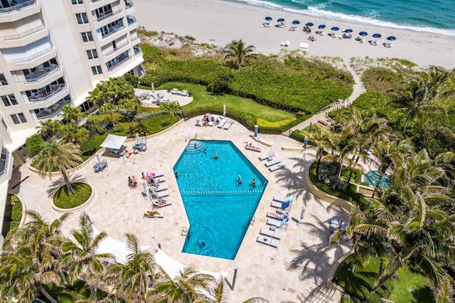 view of pool featuring a beach view and a water view