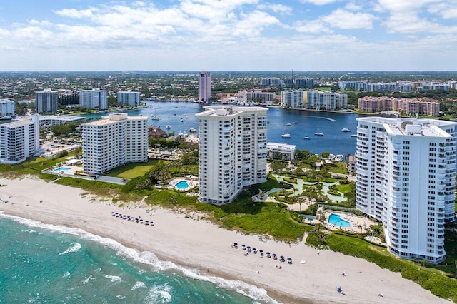 birds eye view of property featuring a beach view and a water view