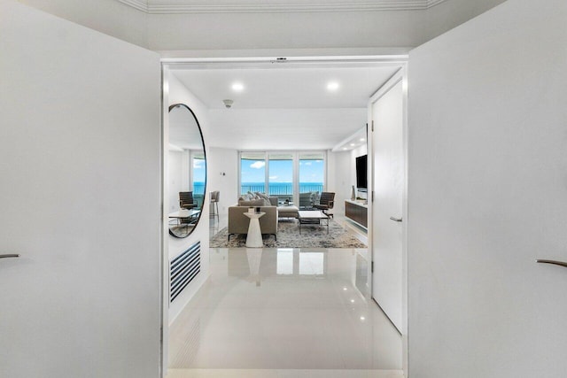 hallway featuring tile floors and a wall of windows