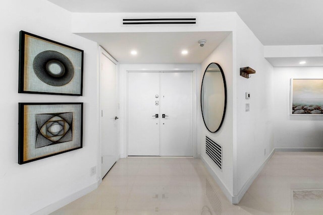 foyer entrance with light tile floors