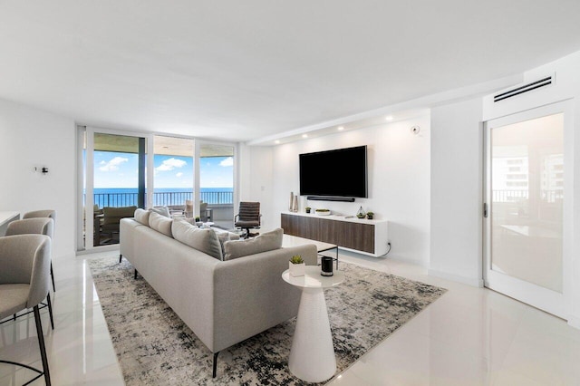 tiled living room with a water view and a wall of windows