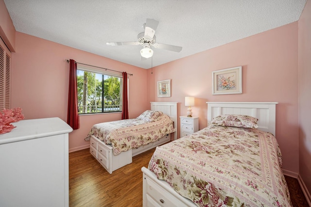 bedroom featuring ceiling fan, a textured ceiling, and light wood-type flooring