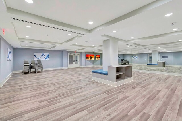 exercise room with a paneled ceiling and carpet