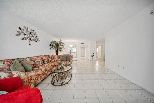 living room featuring a textured ceiling and light tile patterned flooring