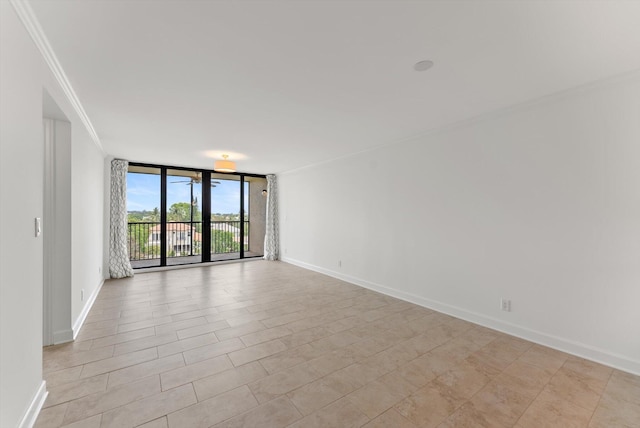 tiled spare room featuring crown molding and expansive windows