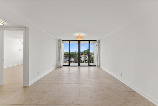 tiled spare room with floor to ceiling windows and ornamental molding