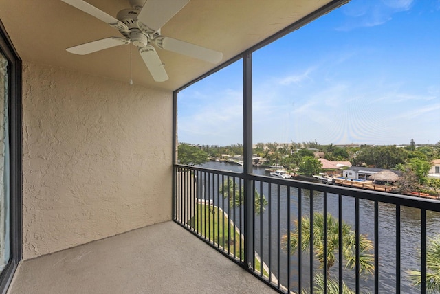 balcony featuring ceiling fan and a water view