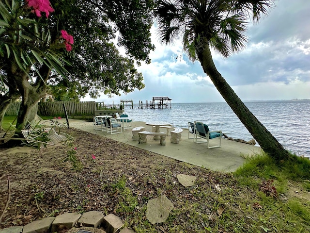 dock area featuring a water view and a patio