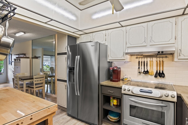 kitchen with appliances with stainless steel finishes, light hardwood / wood-style floors, white cabinetry, and tasteful backsplash