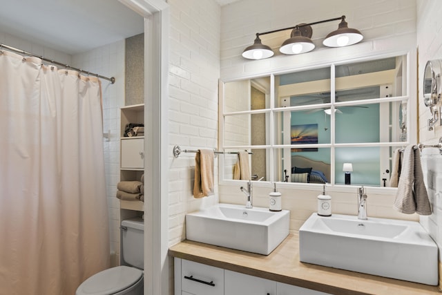 bathroom with brick wall, vanity, and a shower with curtain