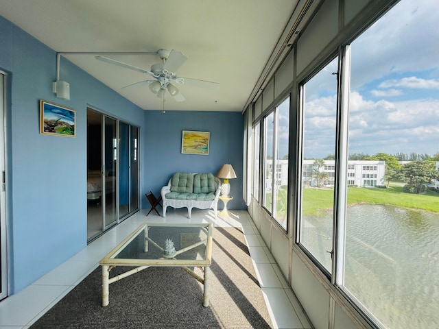 sunroom / solarium featuring ceiling fan