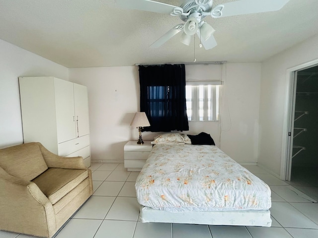 bedroom featuring ceiling fan and light tile flooring