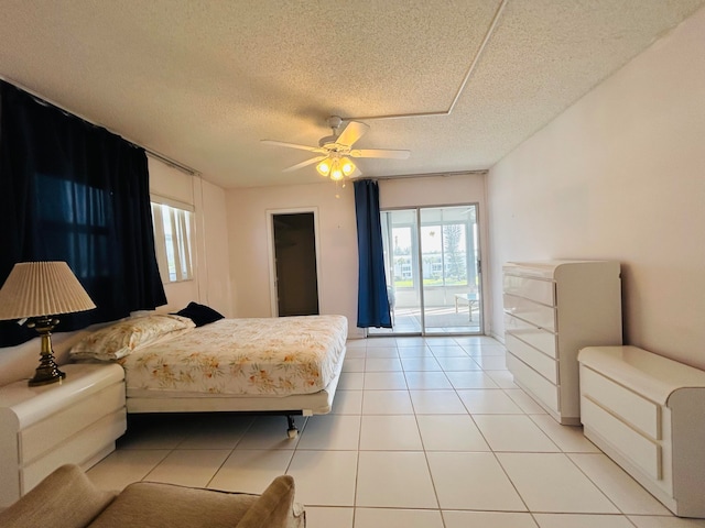 tiled bedroom featuring access to outside, a textured ceiling, and ceiling fan